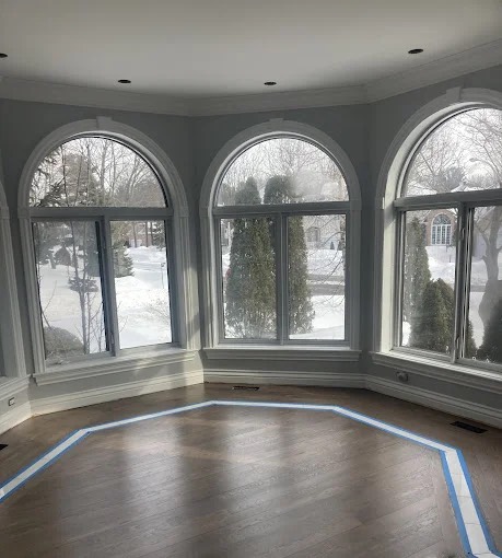 Espresso-stained hardwood floor in a bay-window room